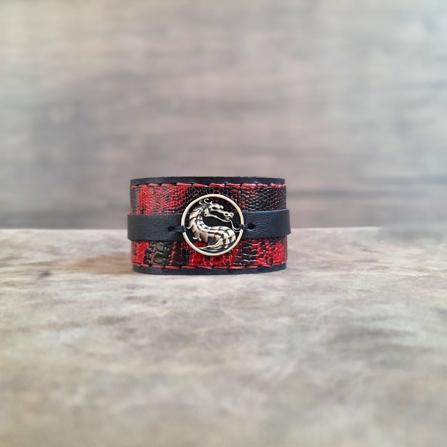 Front View of the layered dragon cuff showing the tarnish-free brass pendant and snake print texture.