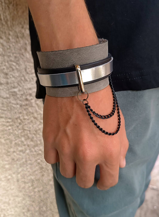 edgy layered urban metallic cuff with black chain worn on wrist