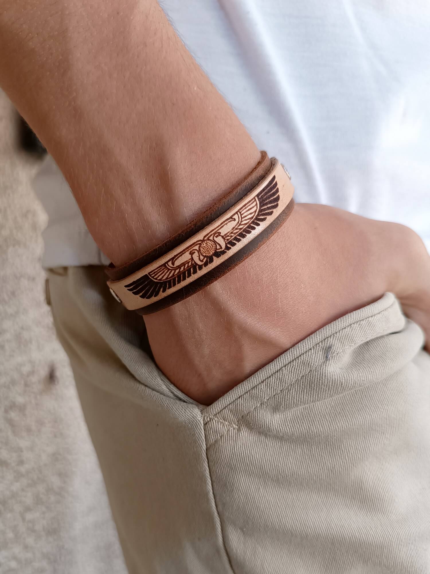 Egyptian Winged Disc Leather bracelet worn on wrist