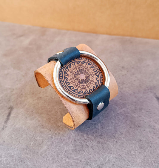 extra wide leather cuff with large metal ring and engraved greek motif