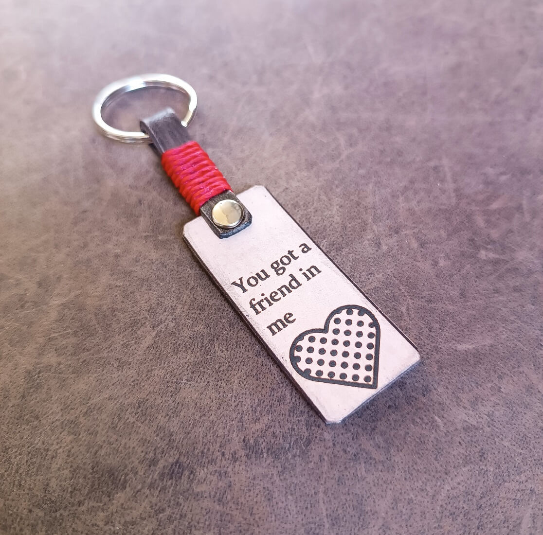 Keychain with motivational quote on a wooden surface