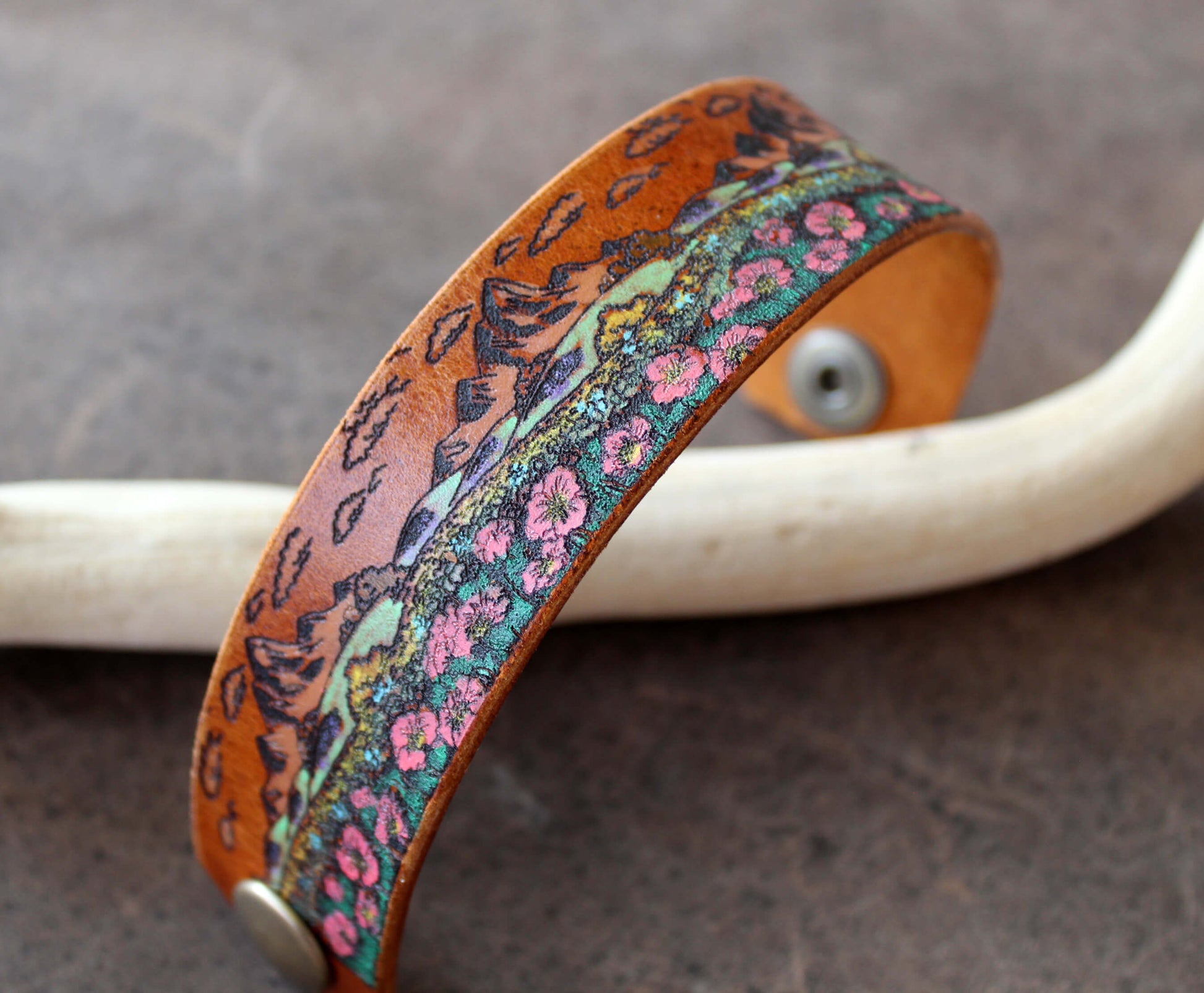 wildflower field cuff full view, showing engraved mountains and hand painted flowers