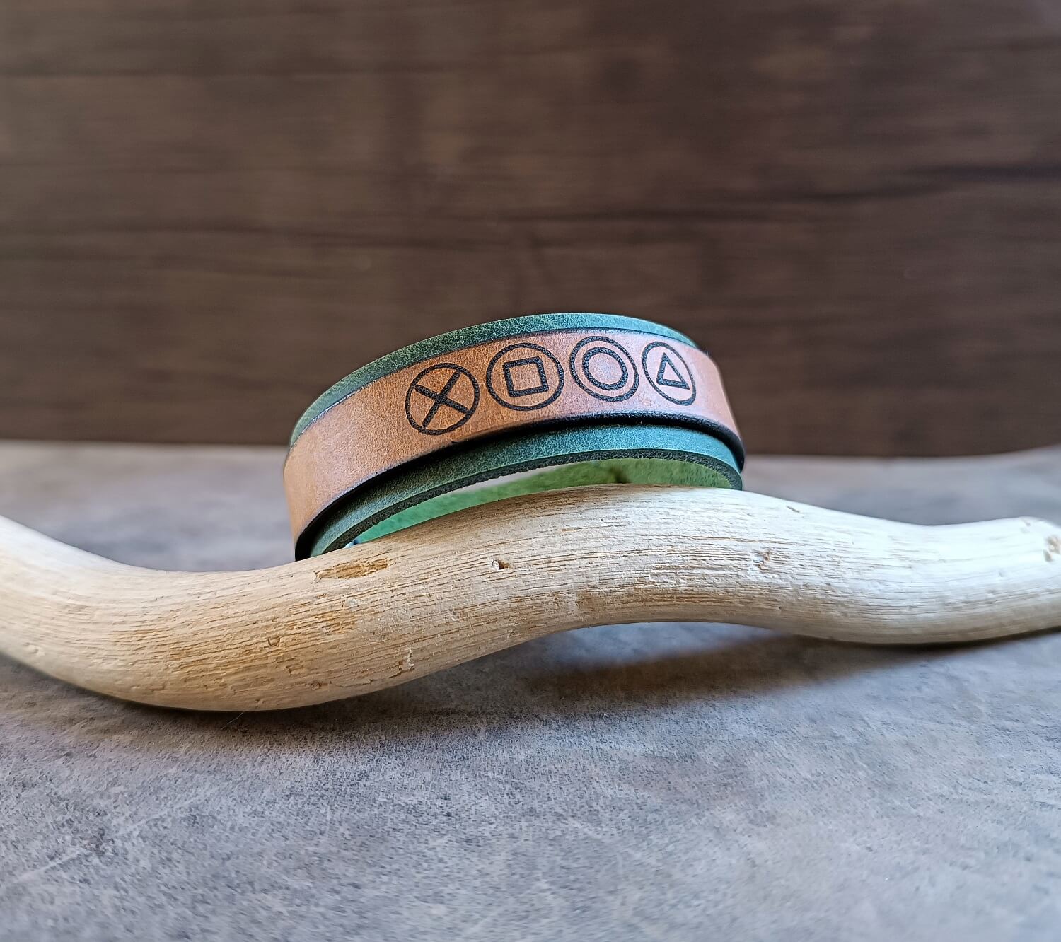 green brown leather cuff with game controller symbols