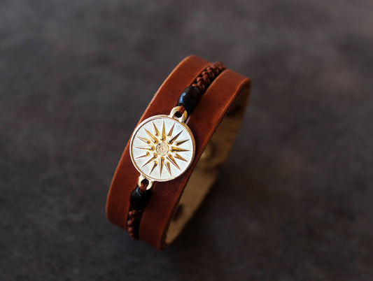 handmade brown leather cuff bracelet featuring a vergina sun pendant