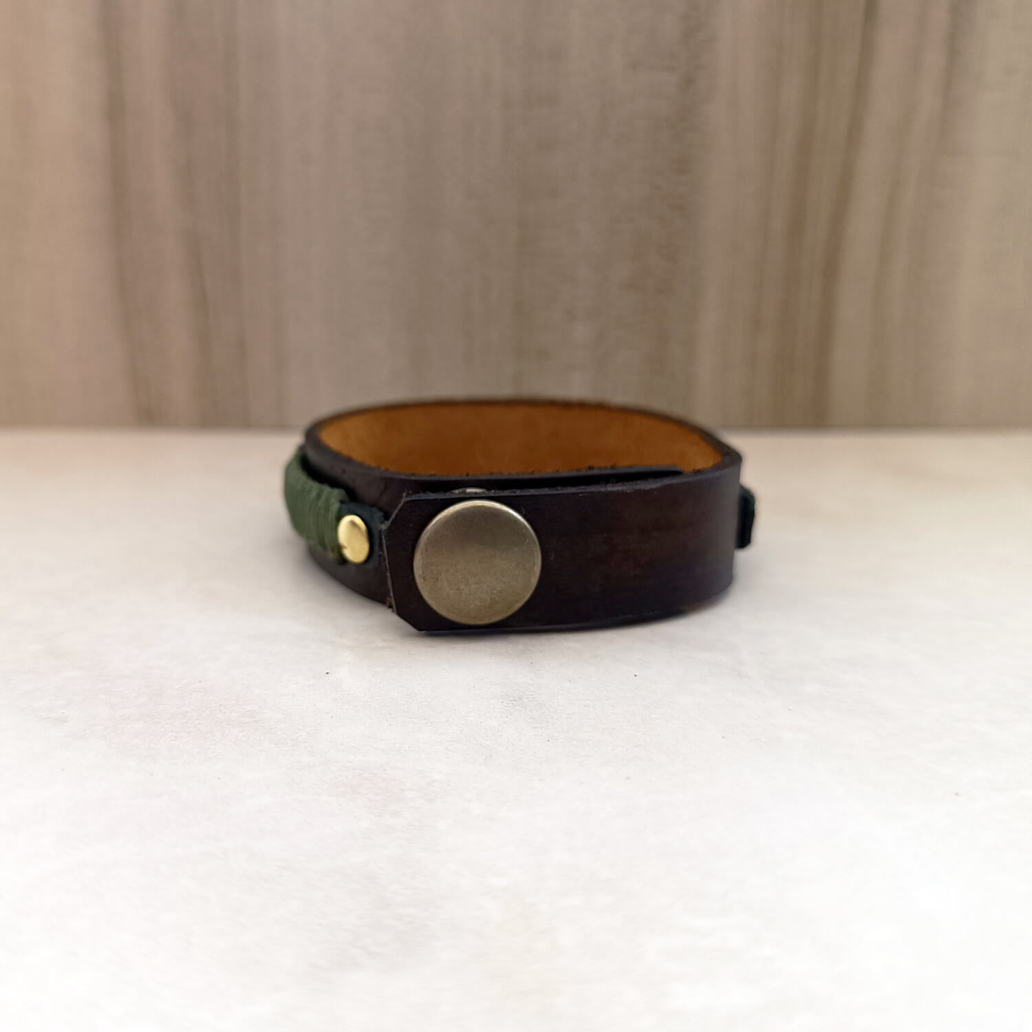 backside view of stainless steel snap button closure with antique bronze cap for visual balance and rugged finish