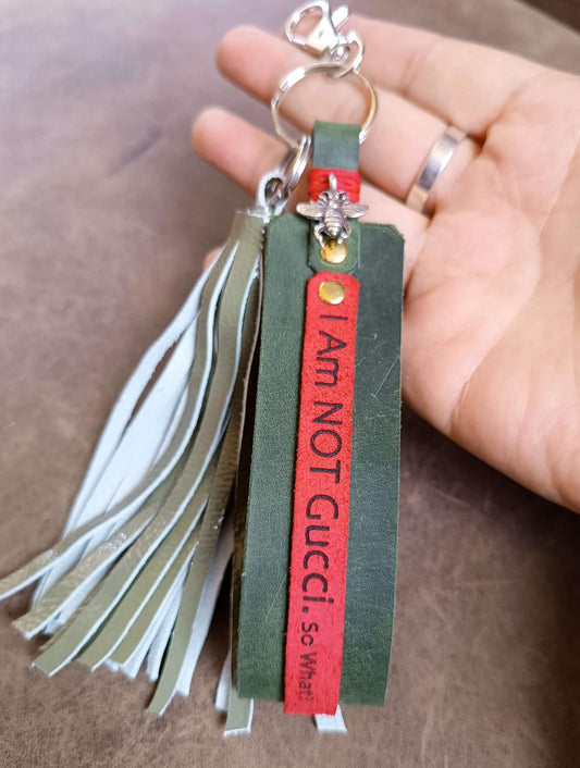 green leather tassel keychain held on hand