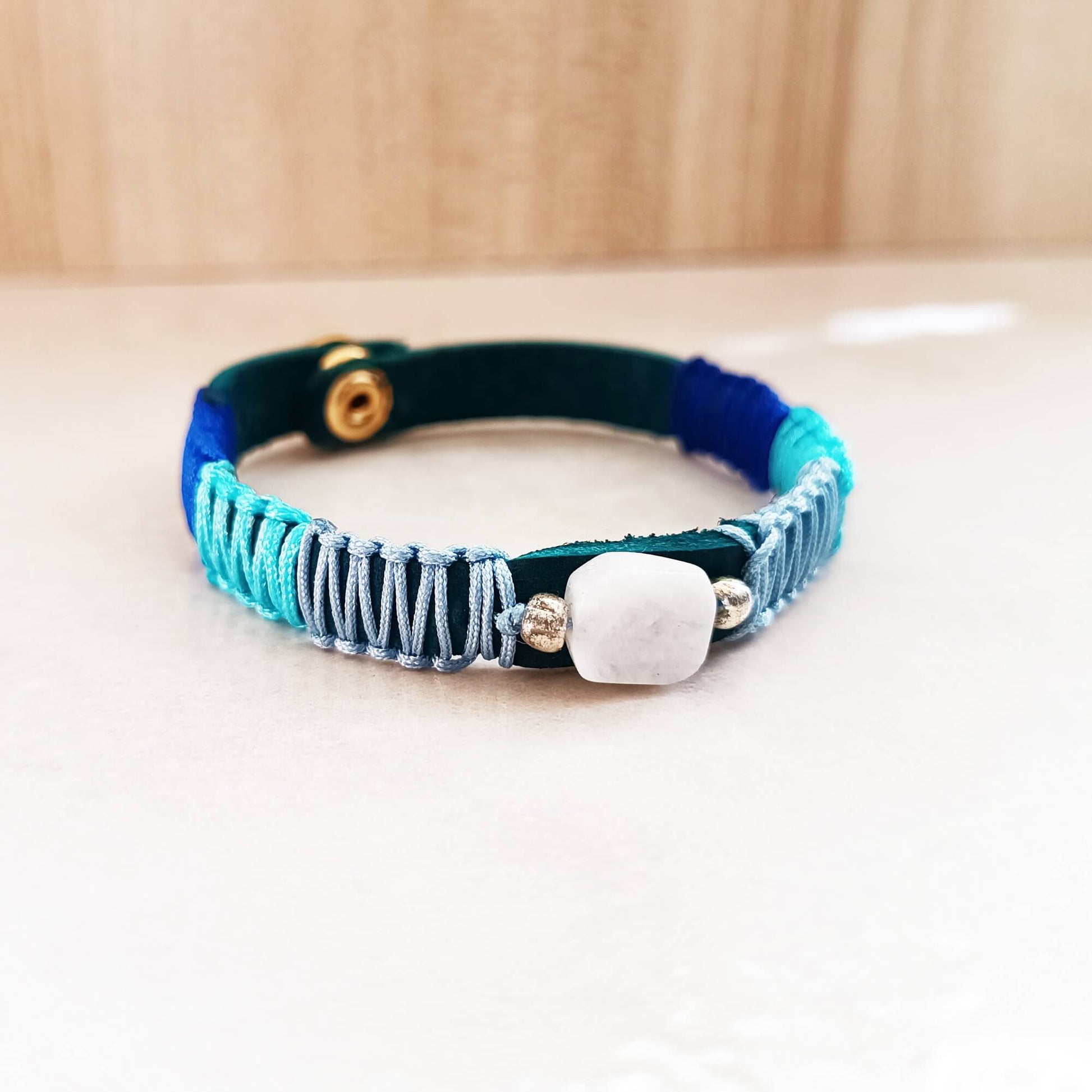 blue leather bracelet with moonstone and macrame in blue hues
