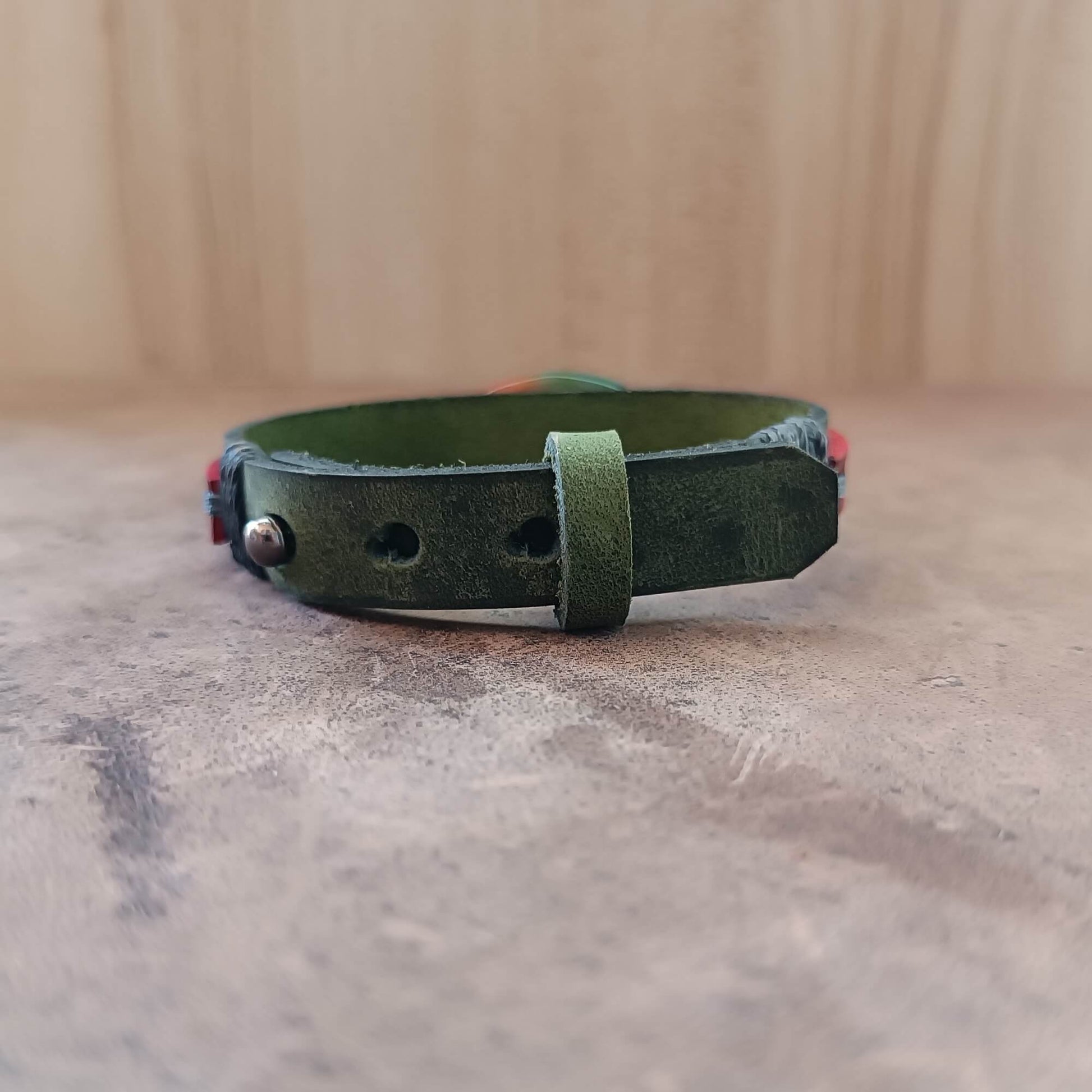 green and red leather Bracelet with a colorful peacock agate bead backside view