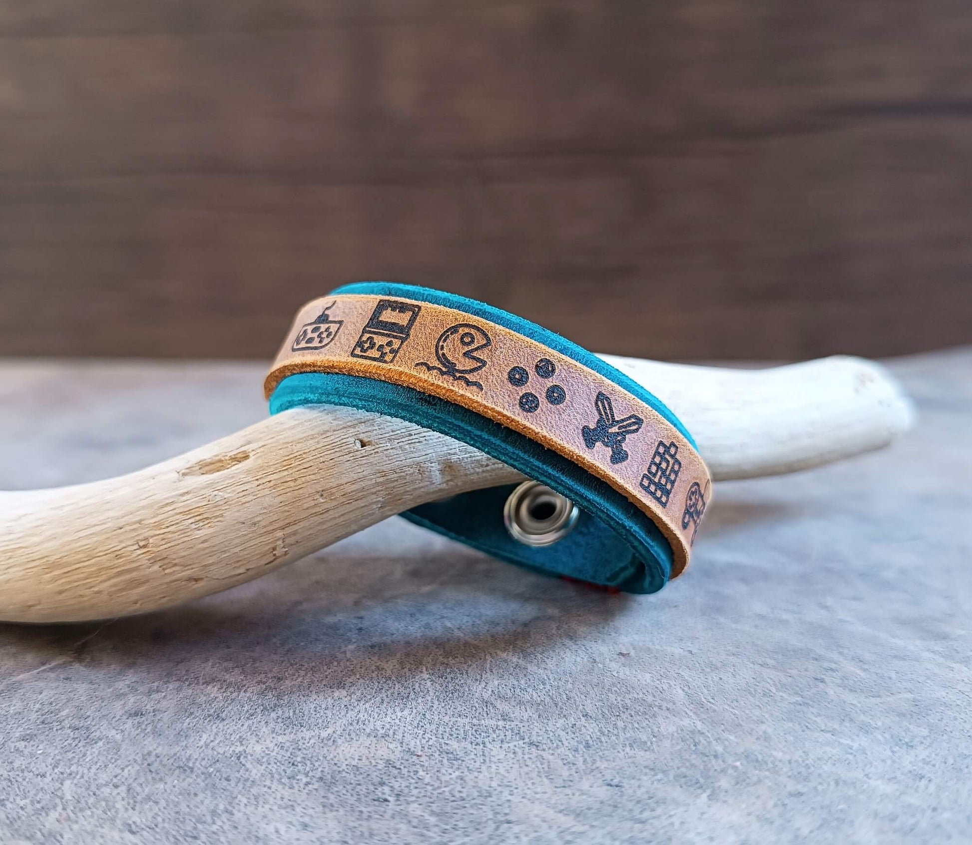 Leather bracelet with engraved symbols on a wooden surface