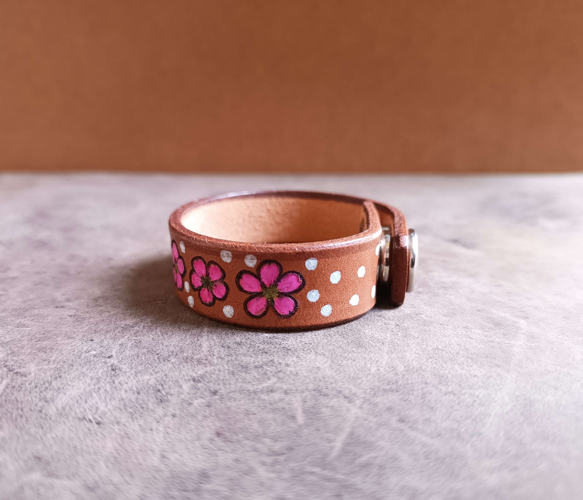 sakura floral leather cuff side view close up, showing snap closure