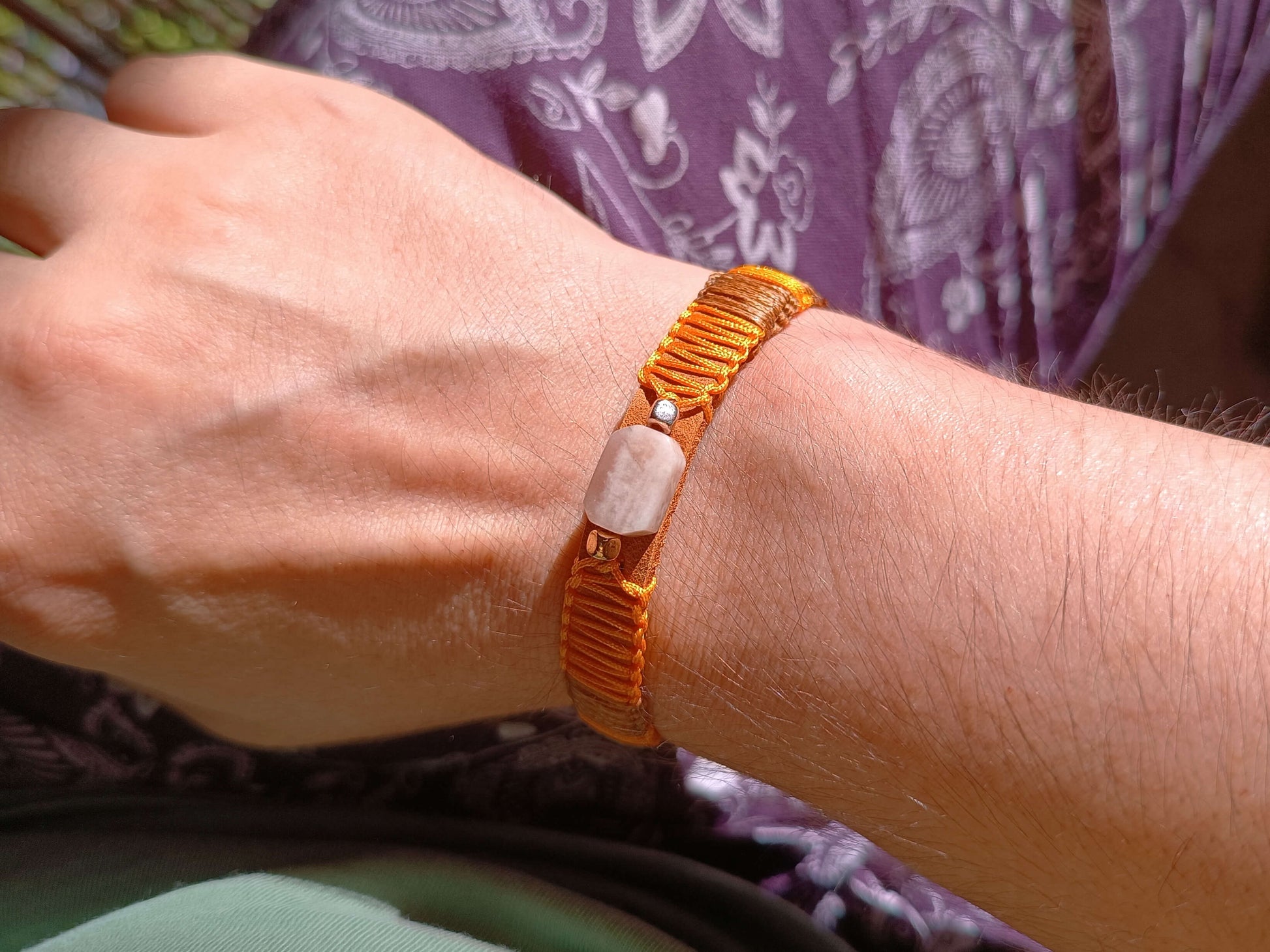 Close-up of a wrist wearing the sunstone leather bracelet