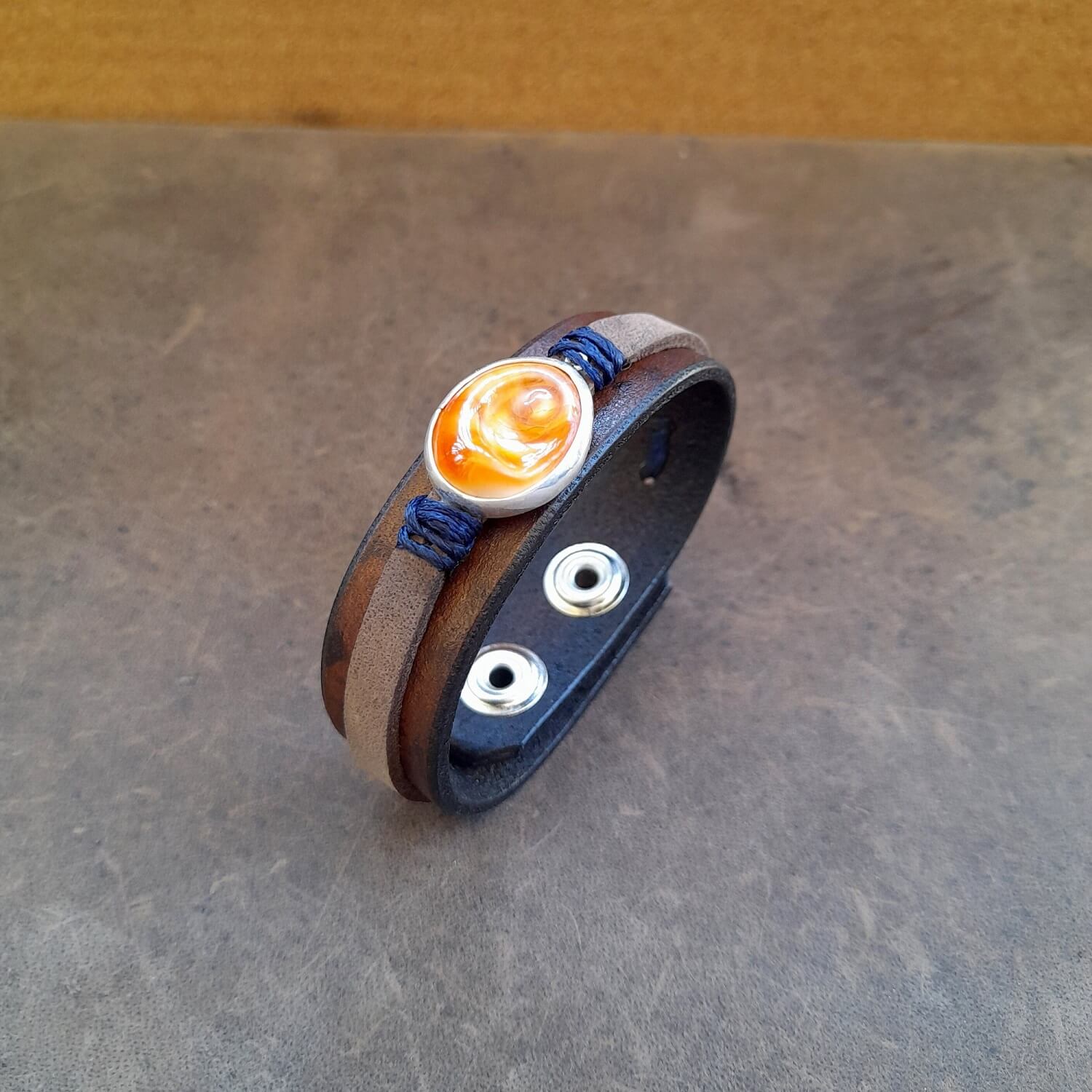 Detailed close-up of the natural Eye of Saint Lucia sea shell pendant on the 'Eye of the Sea' Bracelet, highlighting its unique patterns and sterling silver setting.