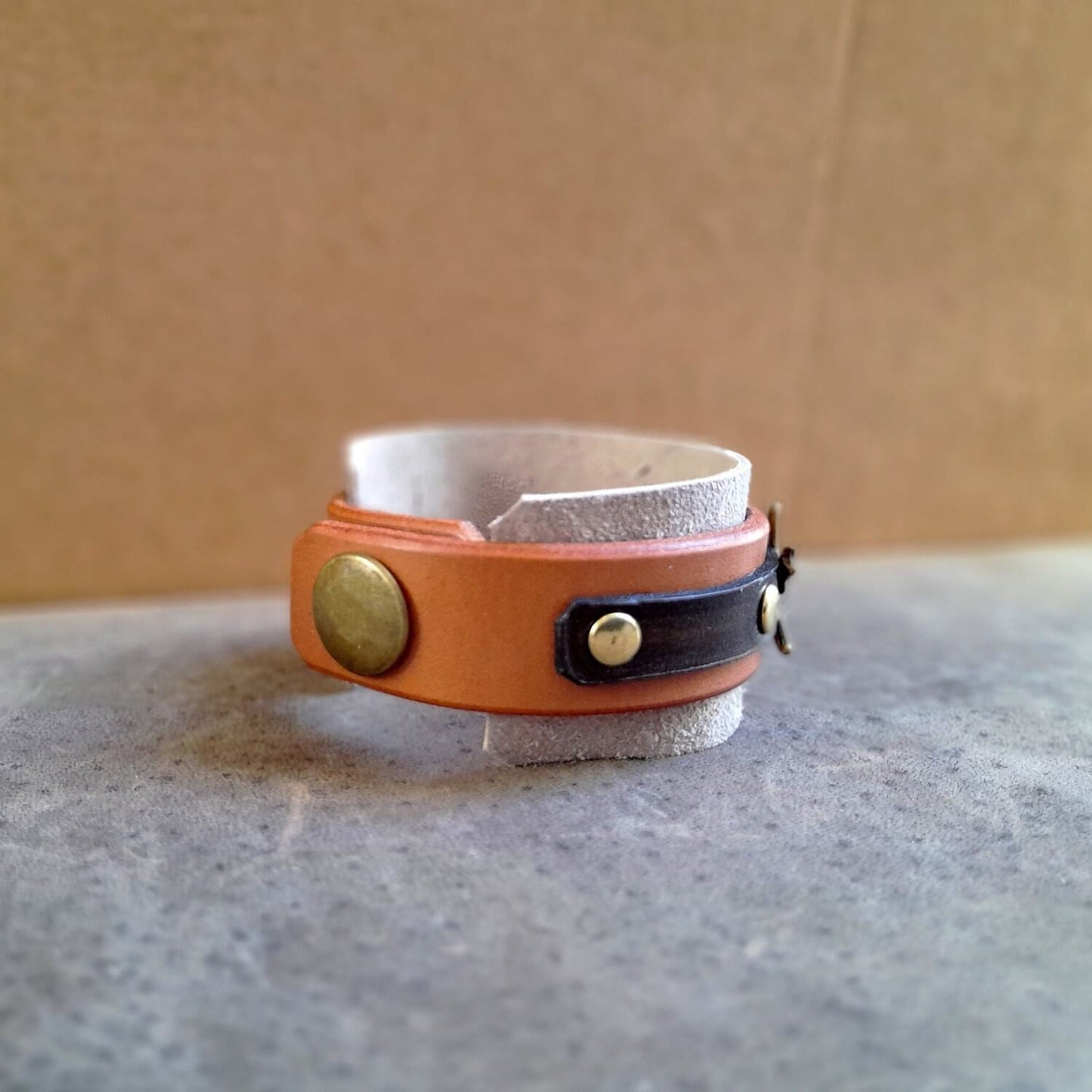 Close-up of the antique bronze snap fastener closure on the "Happy Beige" Mandala Cuff, showing the secure design.