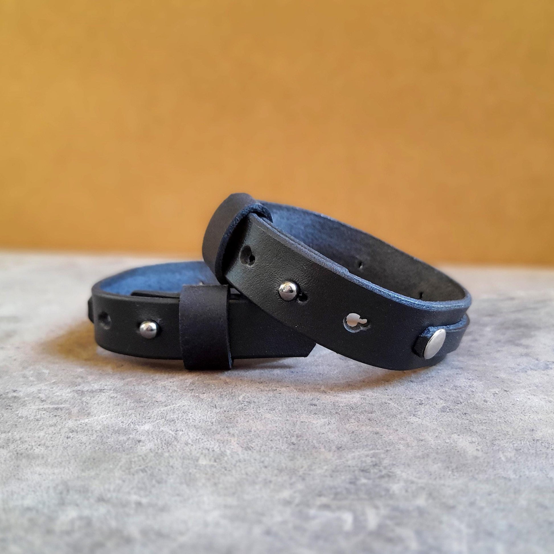 Close-up of the adjustable stud button closure on the Mystic Labradorite Wrap bracelet, showing the multiple openings for a custom fit.