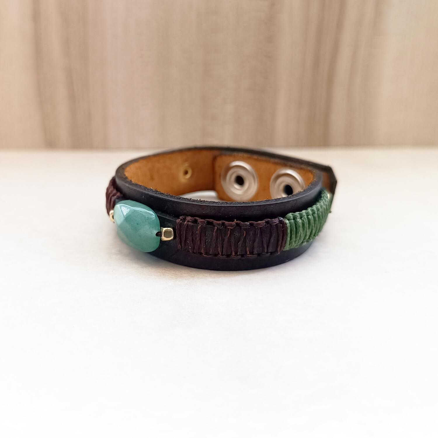 side view of the green aventurine leather cuff, showcasing its sleek top leather strip with macrame knotting.