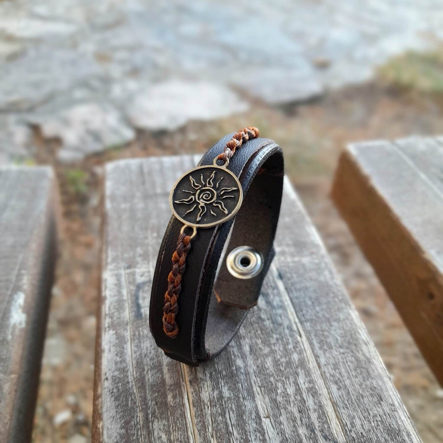 outdoor view of Sunburst Bracelet with macramé details and snap closure