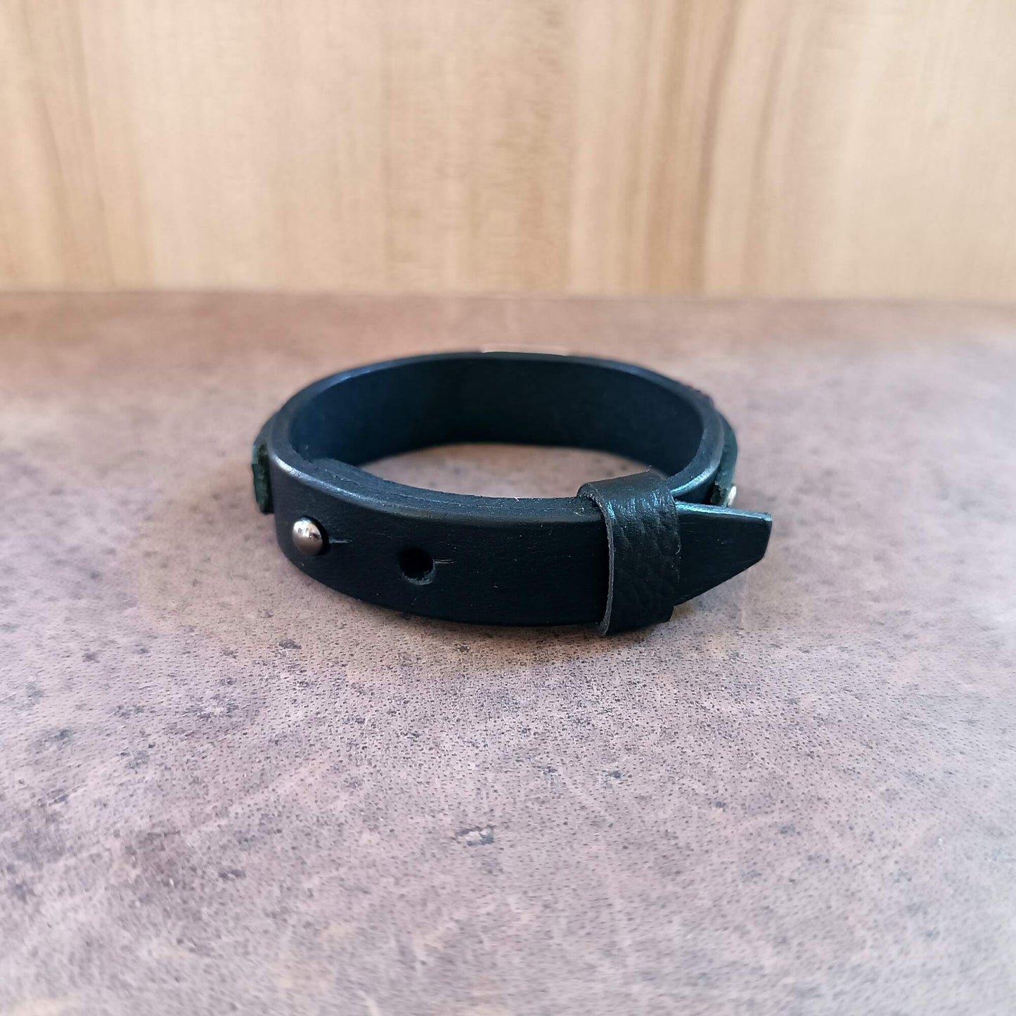 backside view of the black vachetta band, showing closure and openings for adjusting