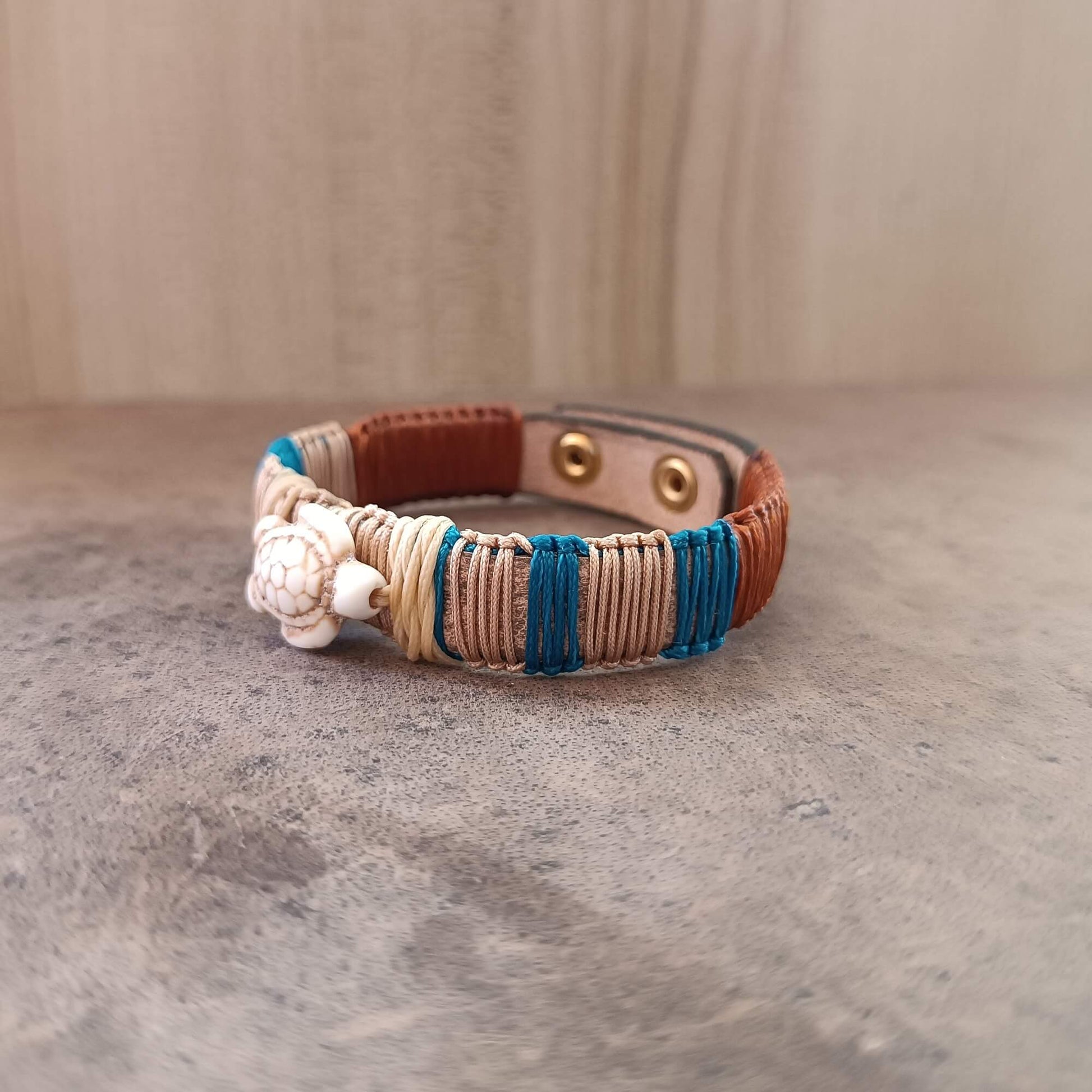 Bracelet with blue and brown accents on a textured surface