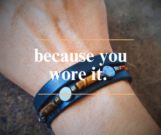 close up shot of a leather bracelet worn on wrist and overlay text