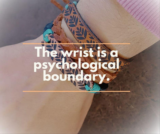 hand wearing multiple handmade leather bracelets