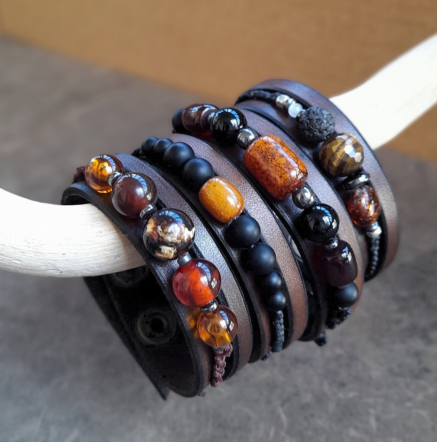 a group photo of 4 leather cuff bracelets, featuring a row of semi precious beads