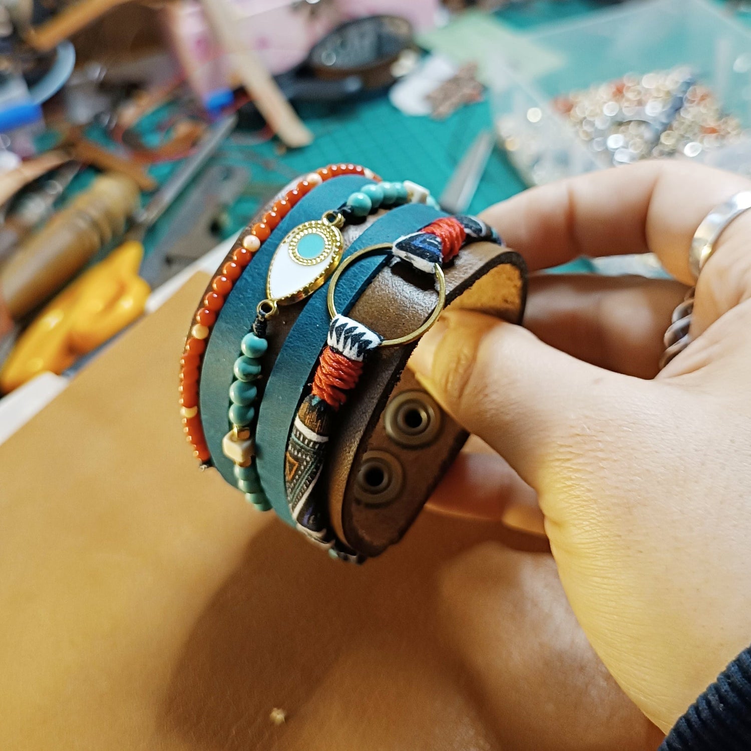 A one of a kind chunky leather cuff in multistrand style, with charms and semi precious beads