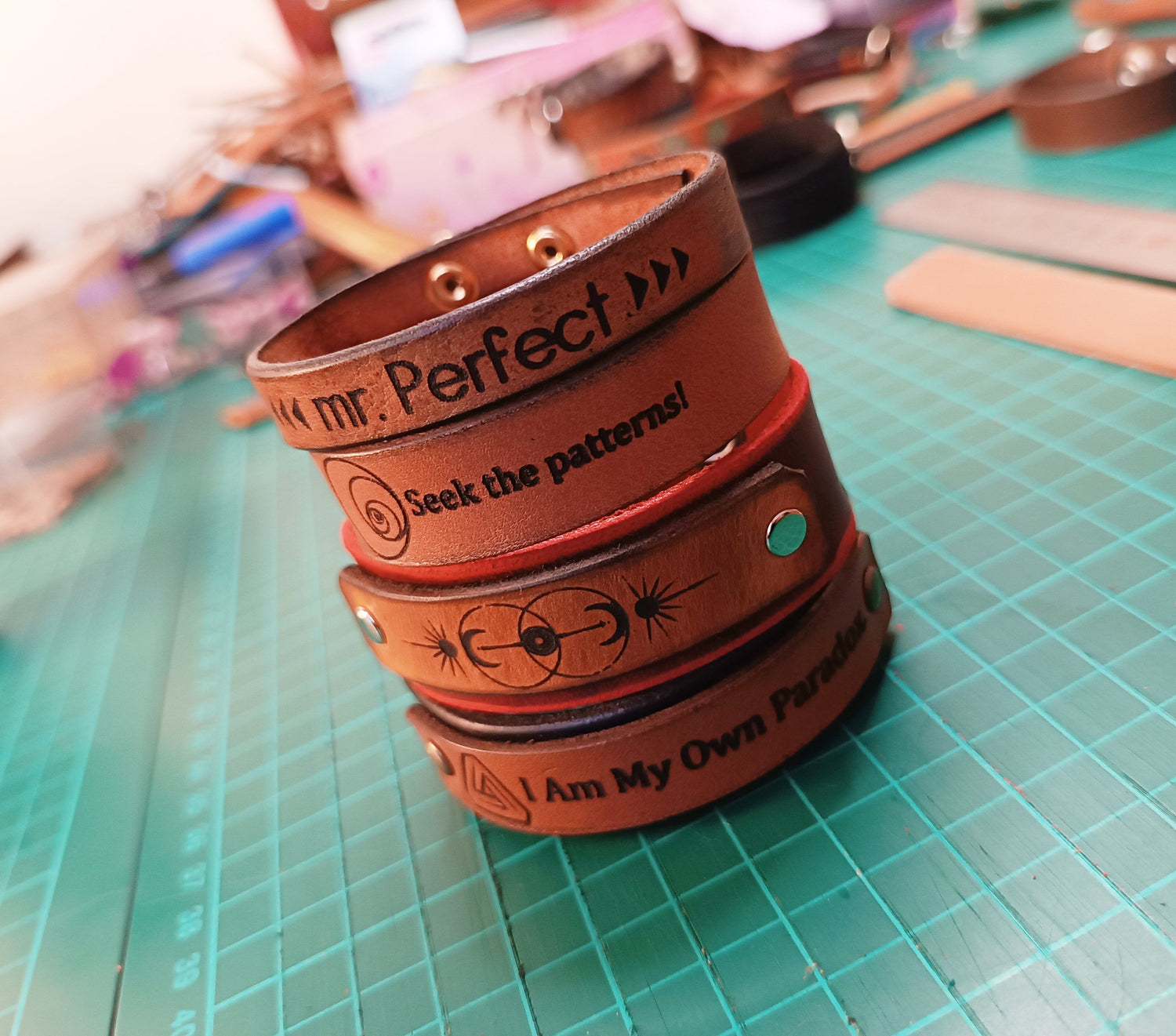 a stack of handmade leather bracelets, STEM,Math and Retro Gaming themed