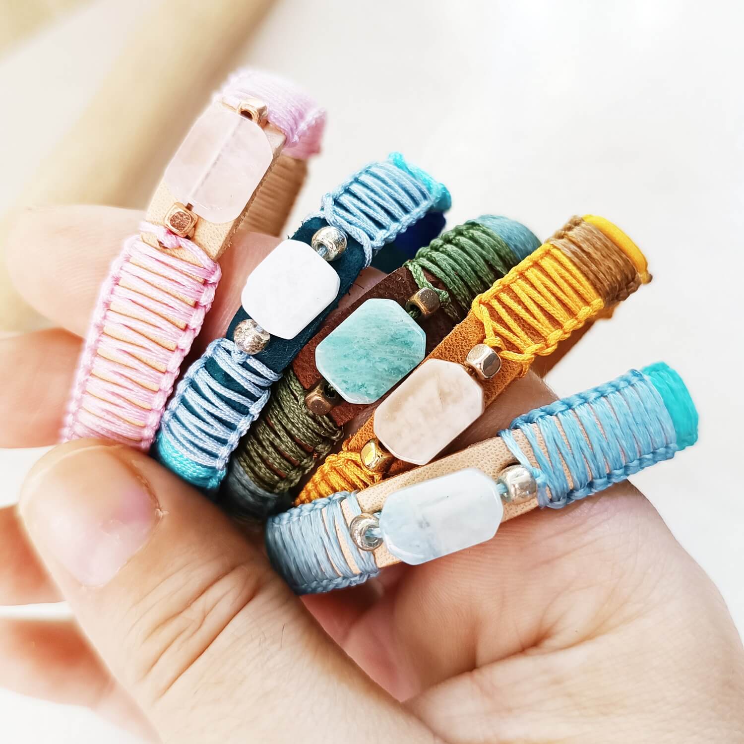 Lucky Seven Leather's Luminous Elements Collection: Handcrafted semi-precious stone & leather bracelets, glowing together.