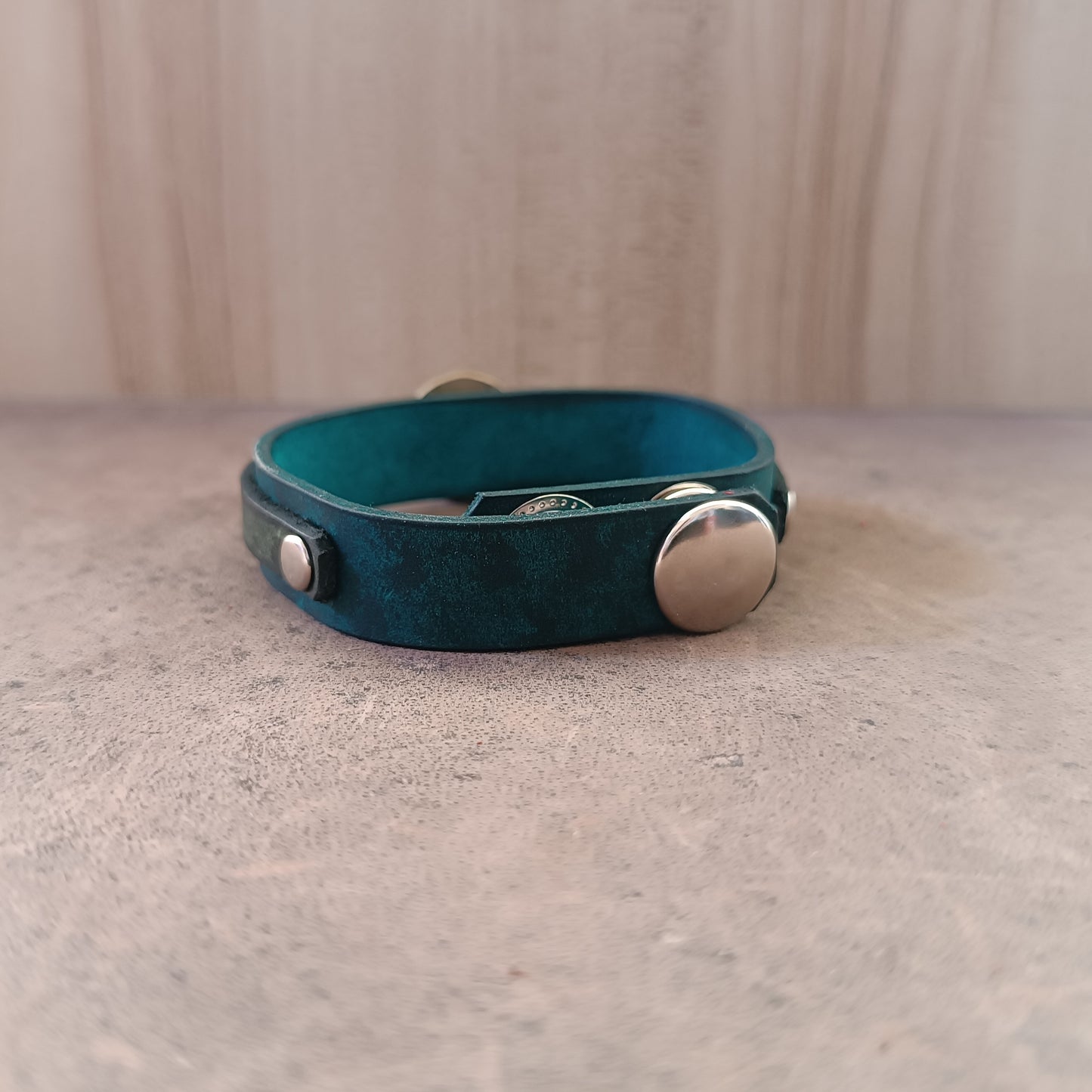 Back of Solar Scarab Bracelet, showing adjustable stainless steel snap buttons closure and soft leather underside.