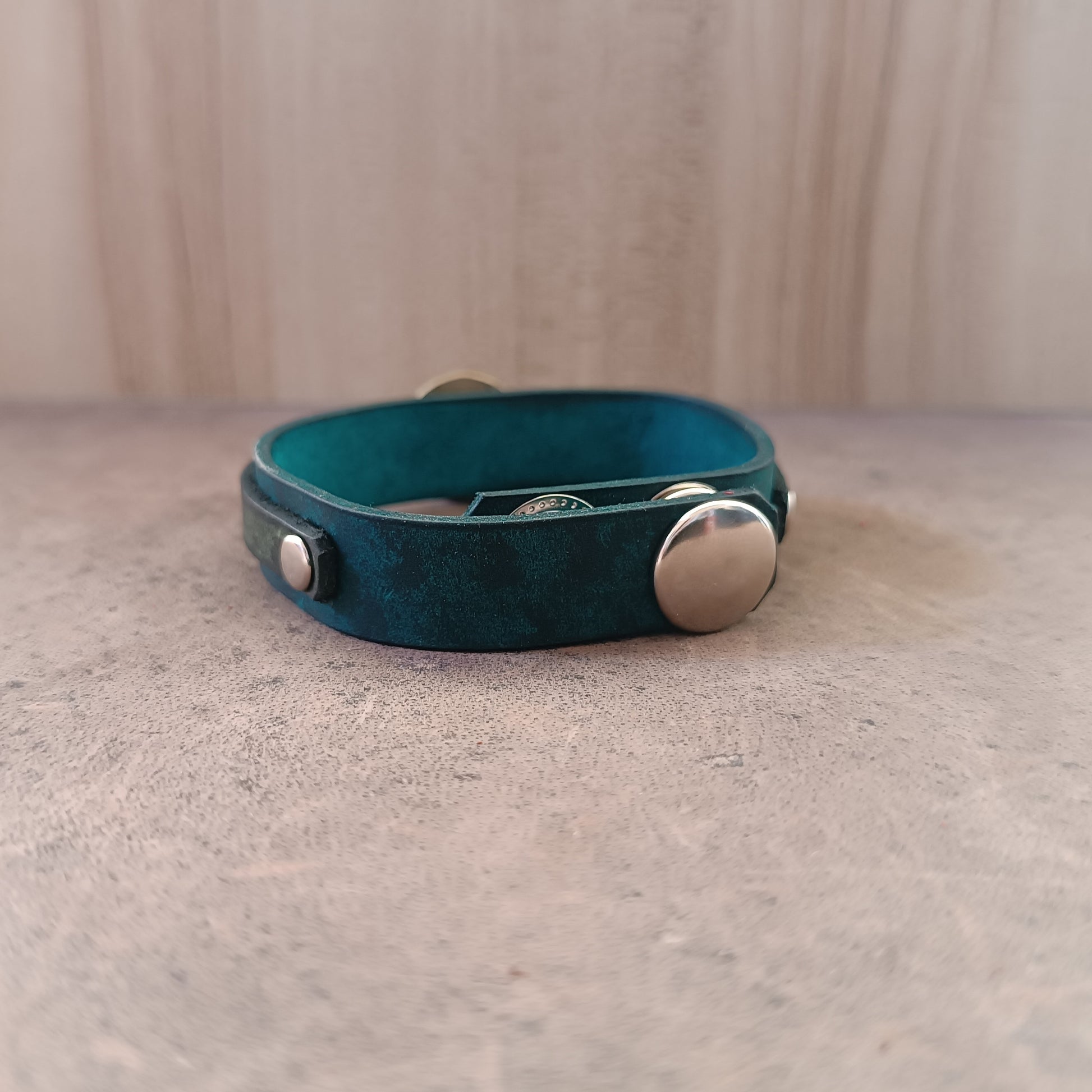 Back of Solar Scarab Bracelet, showing adjustable stainless steel snap buttons closure and soft leather underside.