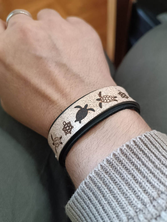Black Tortoise Bracelet worn on wrist showing contrasting leather layers and engraving