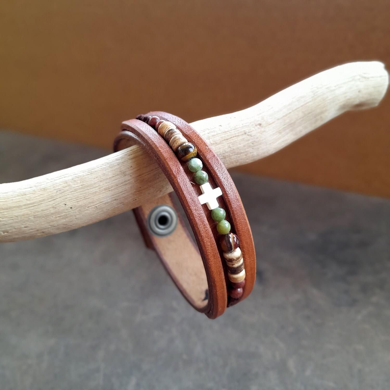Boho beaded leather bracelet for men with green Jasper, Tiger's Eye, coconut beads, and an ivory cross on brown leather.