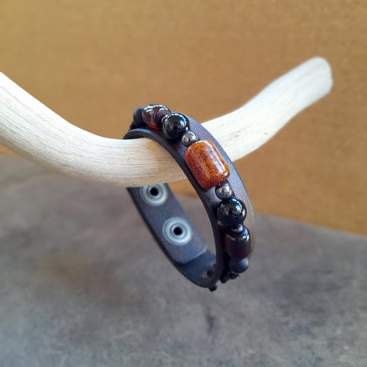 Close-up side view of The Earth & Sky Harmony Bracelet, highlighting the thickness of the chestnut brown Crazy Horse leather and the contrasting natural Black Onyx and Amber barrel beads.