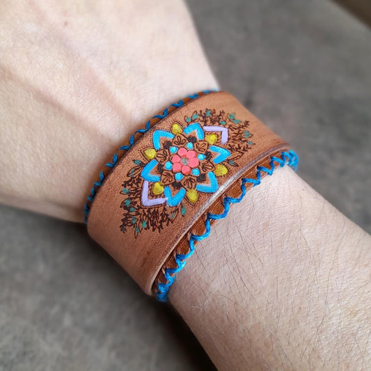 The Hand Painted Mandala Flower Leather Bracelet worn on a wrist, demonstrating its cute boho charm, comfortable fit, and how it brightens an outfit.