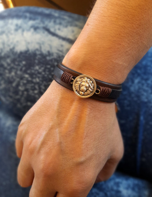 Lion Leather Bracelet worn on a man's wrist, showing its bold style and comfortable fit. Made by Lucky Seven Leather.