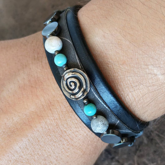 Black leather bracelet with silver spiral and semi precious beads worn on wrist