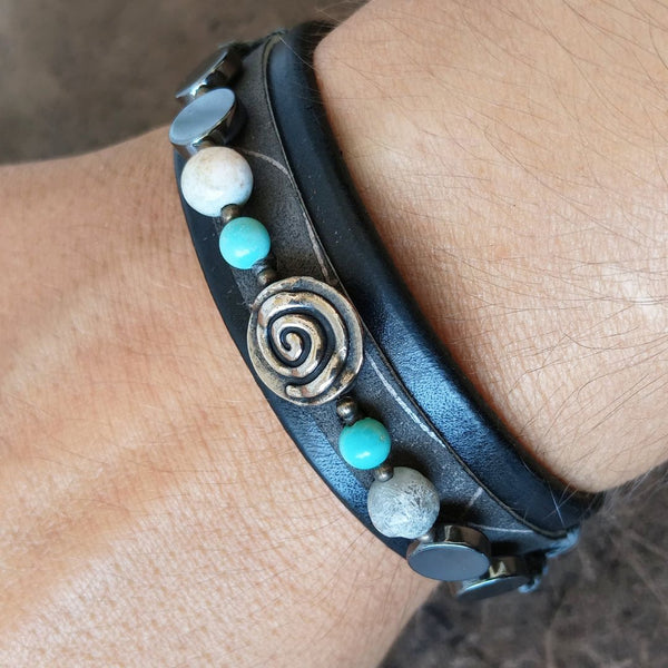 Black leather bracelet with silver spiral and semi precious beads worn on wrist
