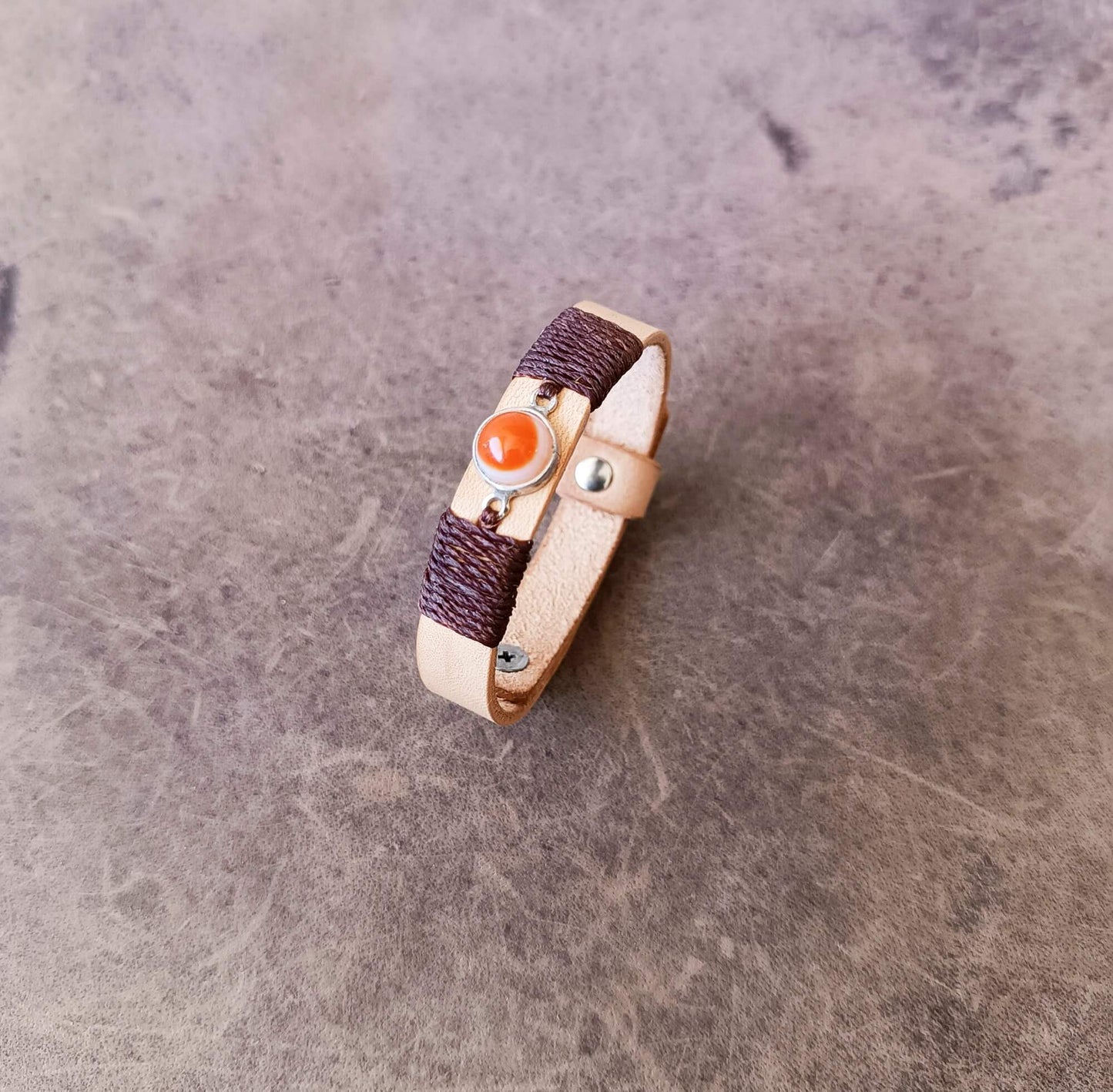 Side angle view of the OOAK beige leather bracelet featuring an Orange Carnelian Agate stone on sterling silver bezel