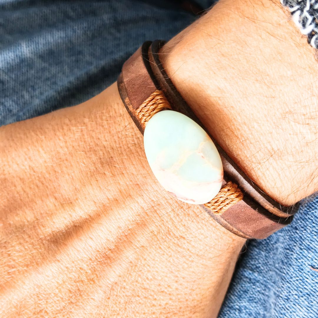 wrist wearing the dark brown leather cuff bracelet featuring a shoushan stone
