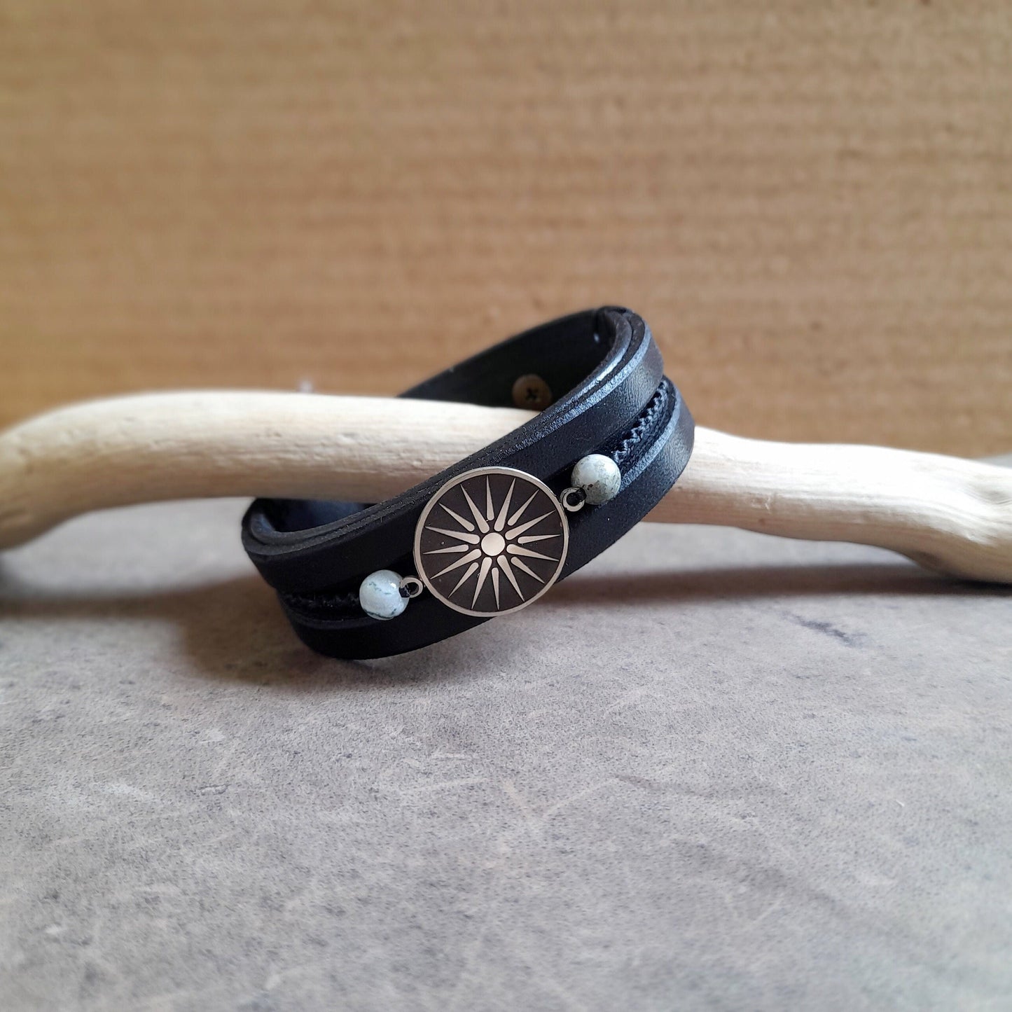Side view of Silver Vergina Sun Black Leather Bracelet, showing three layers of black leather, hand-stitching, Jasper beads, and macrame.