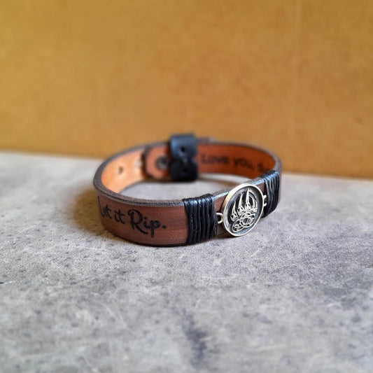 close up Side View of The Bear's Resolve Cuff showing both engraving areas with Let it Rip on the outer side and Love you dude on the underside