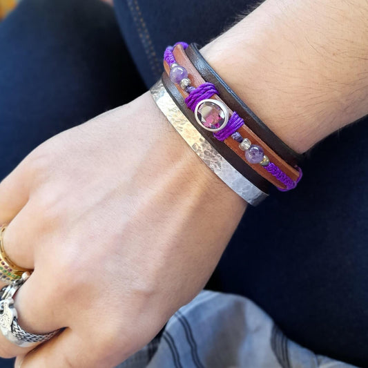 The Purple Zirconia Bracelet worn on a wrist, demonstrating its layered design, vibrant colors, and statement appeal.