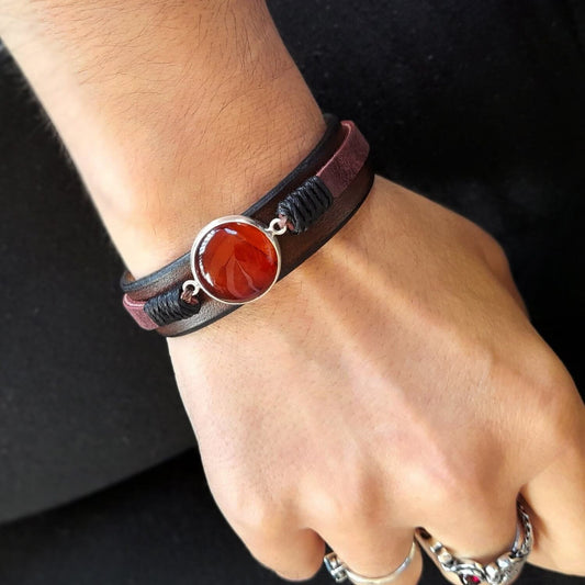 The Red Carnelian Leather Bracelet worn on a wrist, demonstrating its sensual style, comfortable fit, and how it makes a vibrant statement for any wearer.