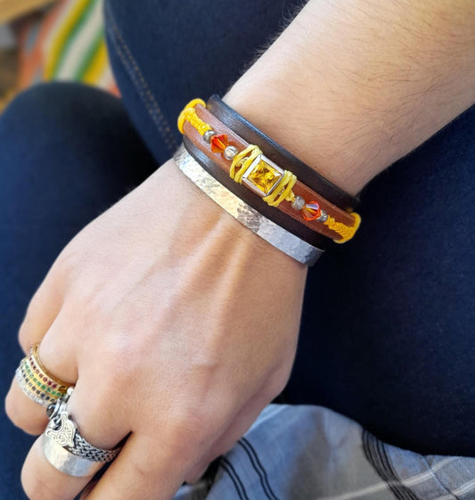 The Yellow Zirconia Bracelet worn on a wrist, demonstrating its layered design, vibrant colors, and statement appeal.