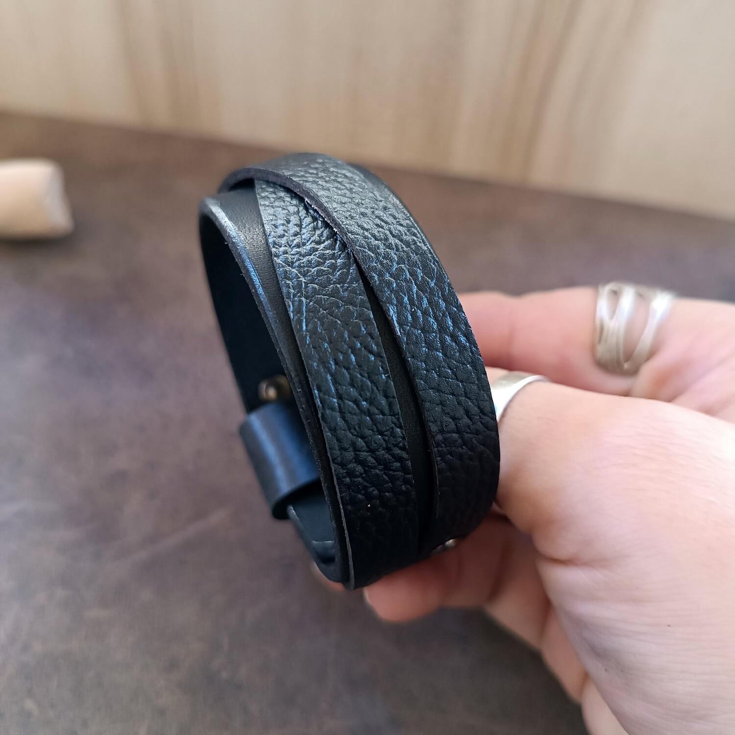 Unisex Wide Black Leather Cuff Bracelet made of premium Vachetta and pebbled leather overlapping straps.