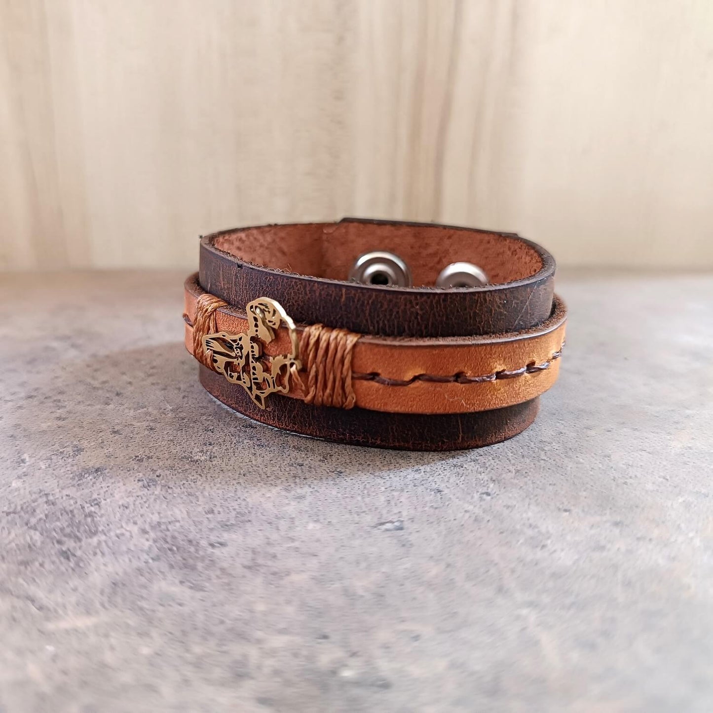 Brown leather bracelet with gold Africa Shaped pendant side view