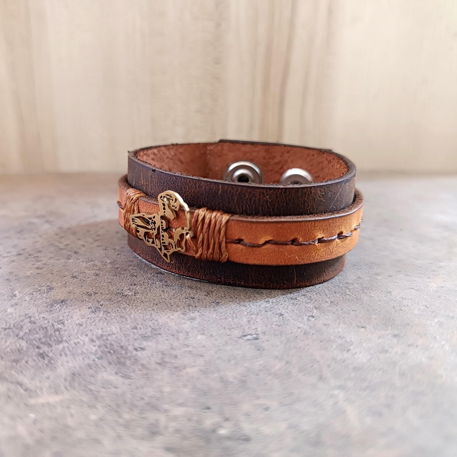 Brown leather bracelet with gold Africa Shaped pendant side view