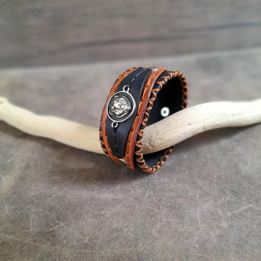 Side angle showing rich leather layers and waxed thread hand-stitching on bear bracelet.