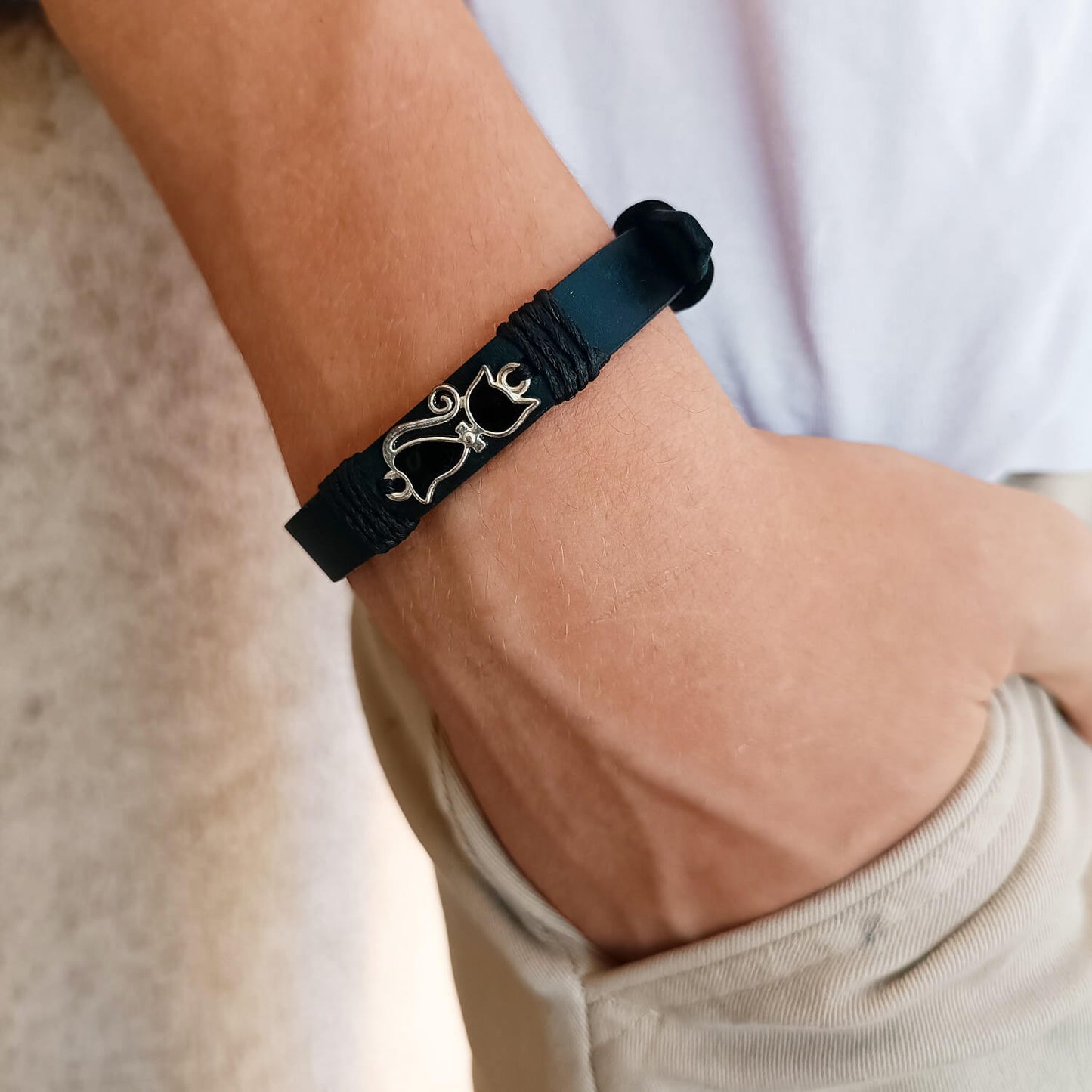Black cat bracelet worn on a wrist 