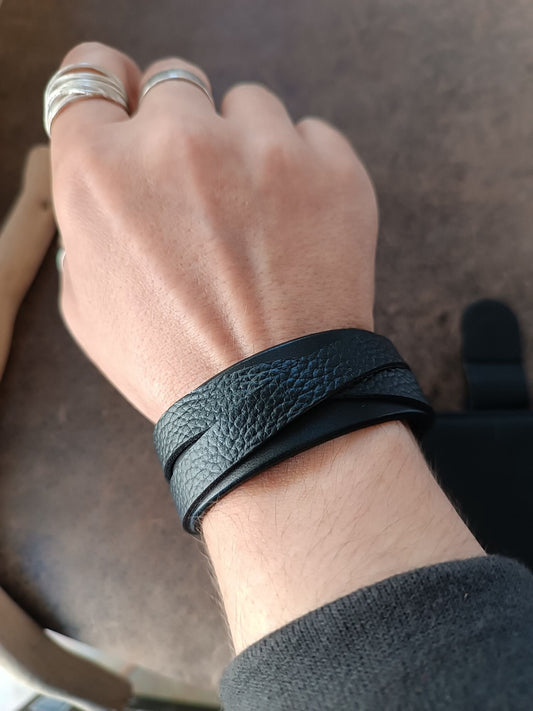 Wide Black Leather Cuff Bracelet for Men and women, made of premium Vachetta and pebbled leather, worn on woman's wrist. Chic and bold without being bulky.
